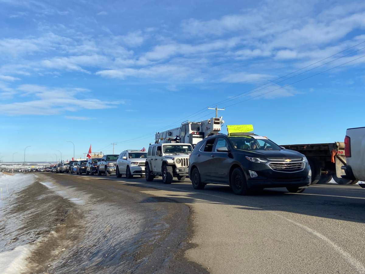 Cars and trucks line Highway 16 as protesters from Acheson head to the Alberta Legislature on Saturday, Jan. 29, 2022.