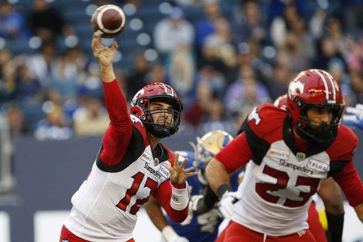 Calgary Stampeders quarterback Jake Maier (12) throws against the Winnipeg Blue Bombers during first half CFL football action in Winnipeg, Sunday, Aug. 29, 2021. 