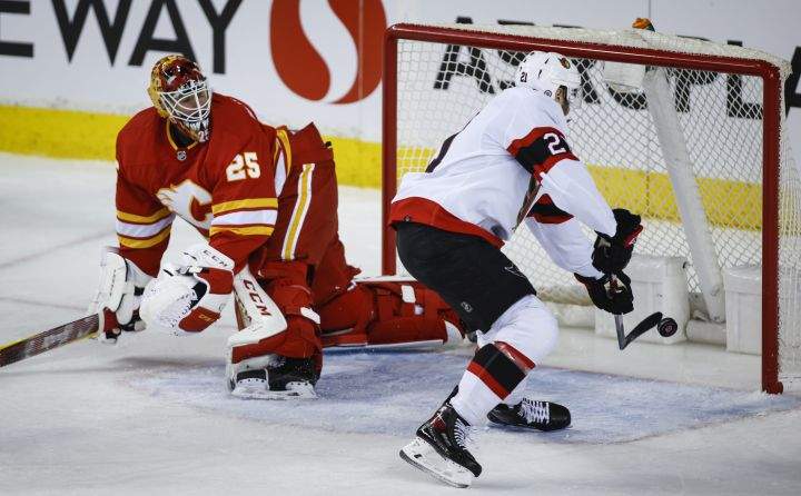 Ottawa Senators’ Nick Paul, right, scores on Calgary Flames goalie Jacob Markstrom during first period NHL hockey action in Calgary, Thursday, Jan. 13, 2022.