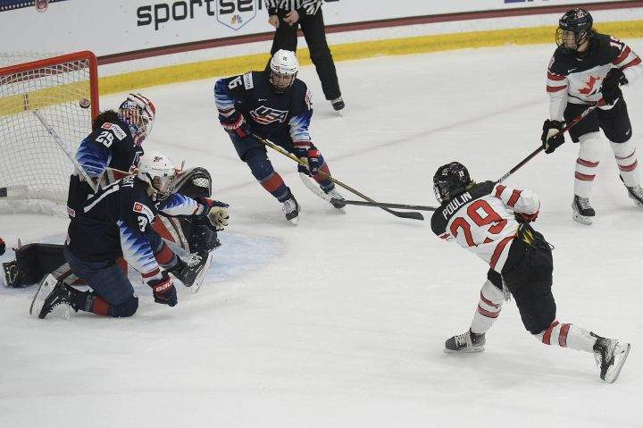 Canada’s Marie-Philip Poulin (29) shoots the game winning goal during the overtime period of a women’s exhibition hockey game ahead of the Beijing Olympics, Friday, Dec. 17, 2021, in Maryland Heights, Mo.
