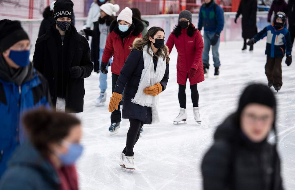 People skate on the Rink of Dreams at City Hall in Ottawa, on Tuesday, Dec. 28, 2021. 