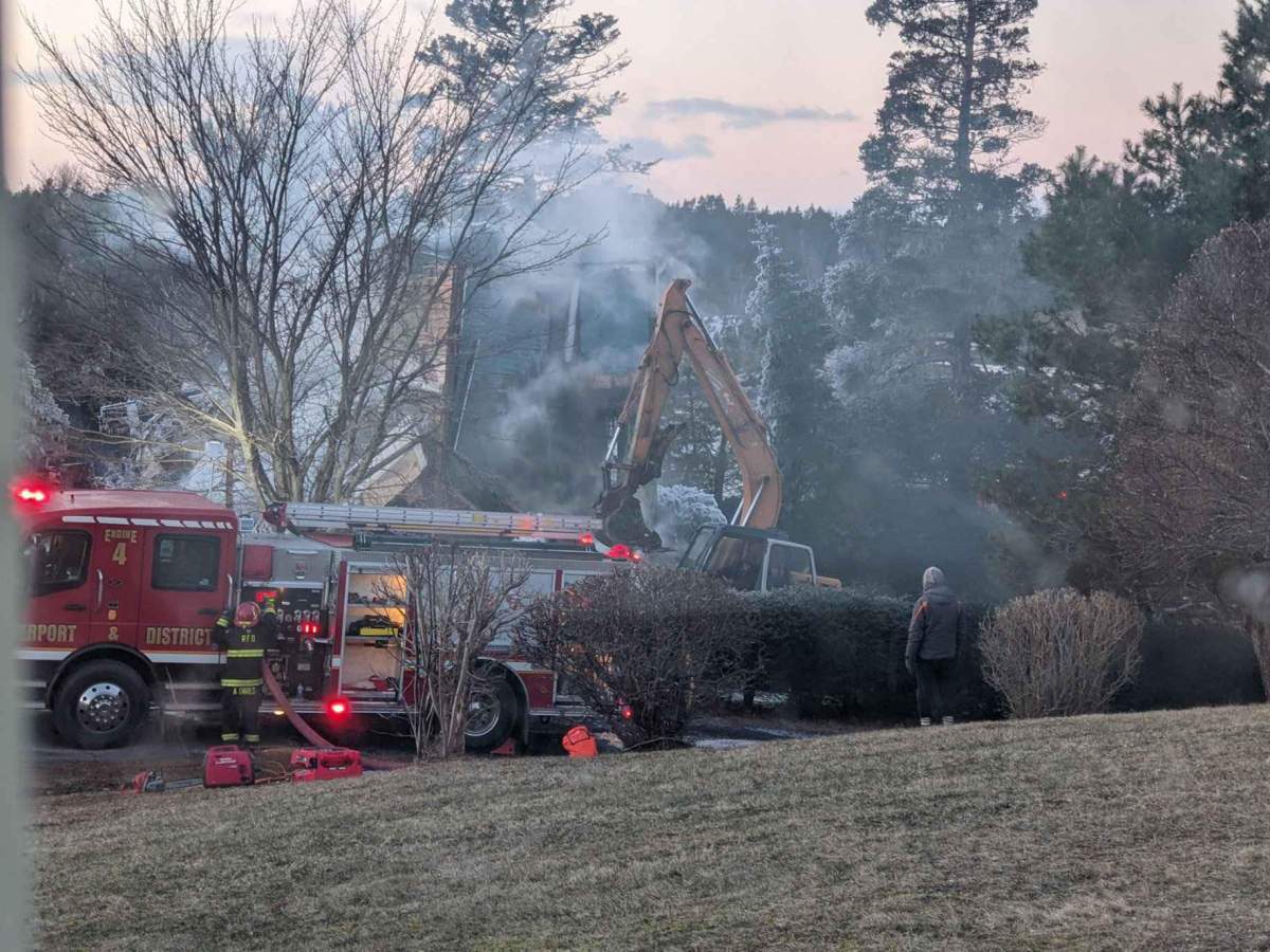 Chris Anderson is pictured surveying the damage, after fire destroyed his home in Bayport, N.S. 