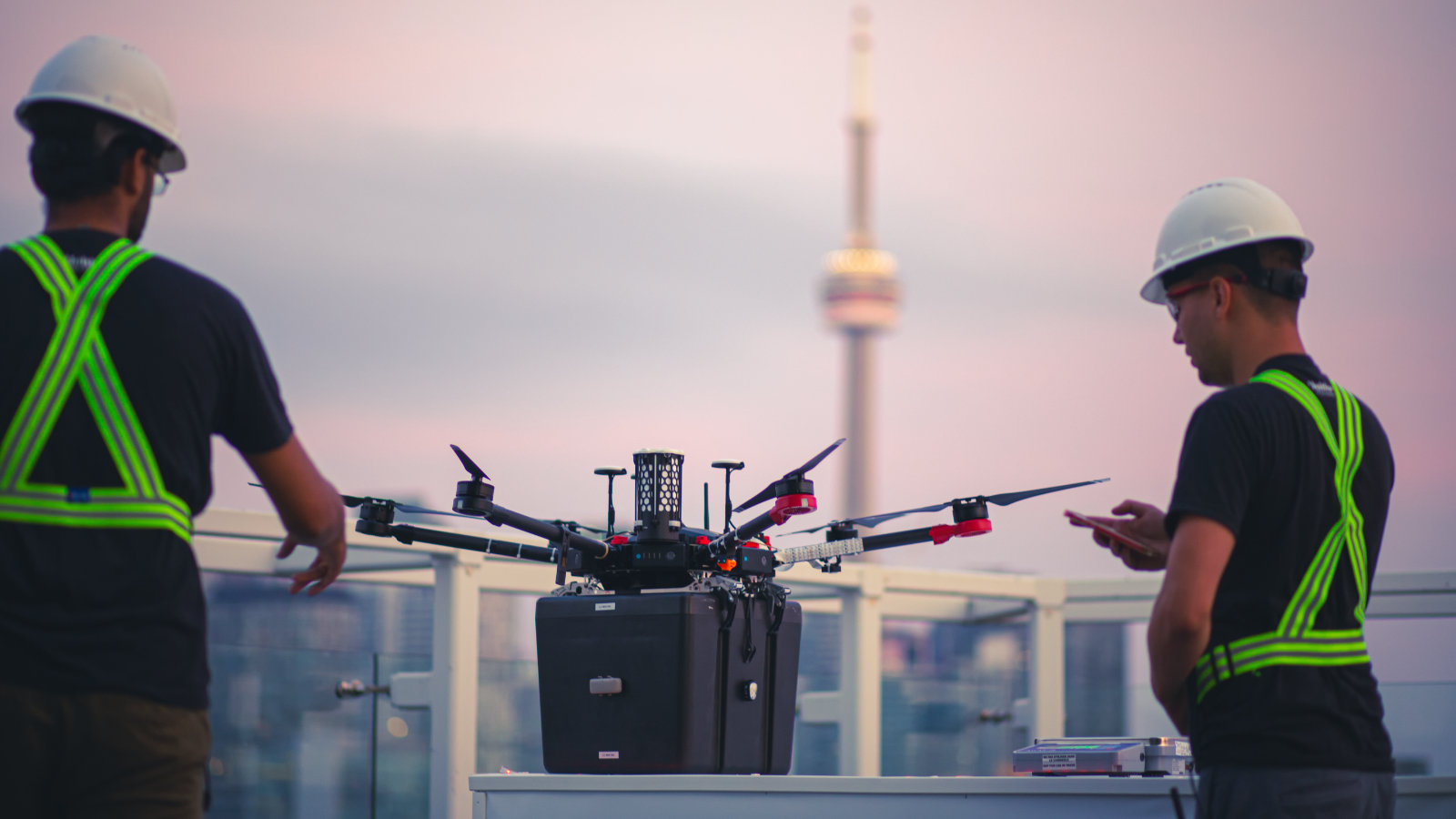 Two workers prep a drone for organ delivery in Toronto