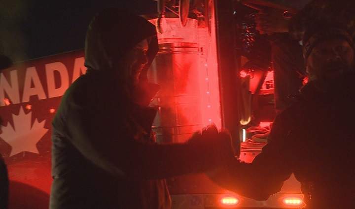A still image is captured showing Regina—Qu’Appelle Conservative MP Andrew Scheer shaking hands with an individual as the trucker convoy passed through on Monday night in Regina.