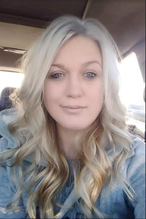 Candice Murley poses for a selfie in her car