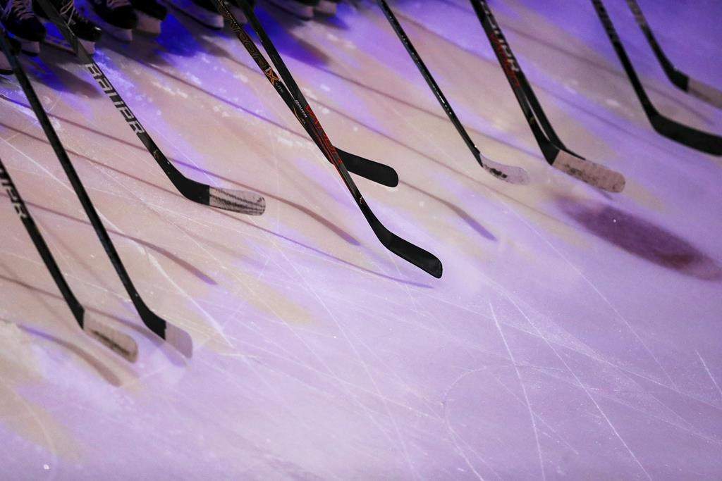 FILE - Ferris State players hold hockey sticks prior to an NCAA hockey game against the Miami RedHawks, on Oct. 18, 2019, in Oxford, Ohio. Before arriving at Miami University in Ohio, as director of hockey operations, Brad Aldrich had been allowed to resign from the Blackhawks over accusations of sexually assaulting a player. A November 2012 sexual assault allegation against Aldrich at Miami led to his resignation. (AP Photo/Aaron Doster, File).