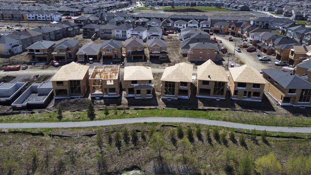 FILE. New homes are built in a housing construction development in the west-end of Ottawa on Thursday, May 6, 2021. Ontario needs to quickly and aggressively build more housing supply - with a goal of 1.5 million homes in 10 years - to address the province's housing crisis, by increasing density, and limiting consultations and appeals, expert advisers said Tuesday.