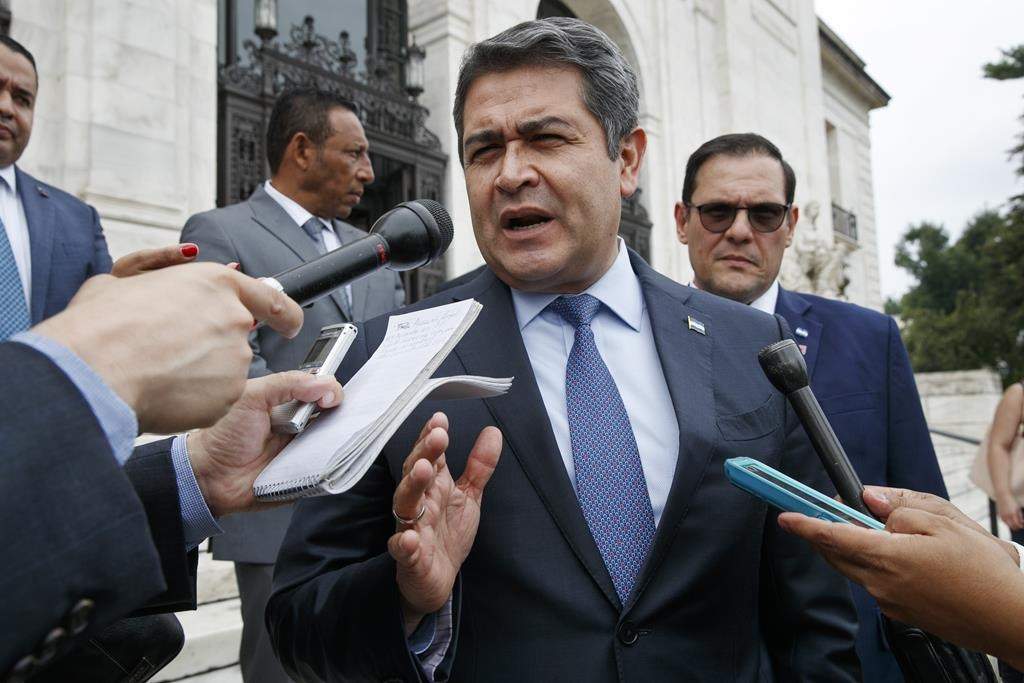 FILE - Honduran President Juan Orlando Hernandez answers questions from the Associated Press, Tuesday, Aug. 13, 2019, as he leaves a meeting at the Organization of American States, in Washington. (AP Photo/Jacquelyn Martin,File).