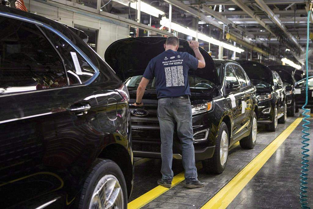 Vehicles sit on a production line at the global production start of the 2015 Ford Edge at the Ford Assembly Plant in Oakville, Ont., on Thursday, February 26, 2015. THE CANADIAN PRESS/Chris Young.