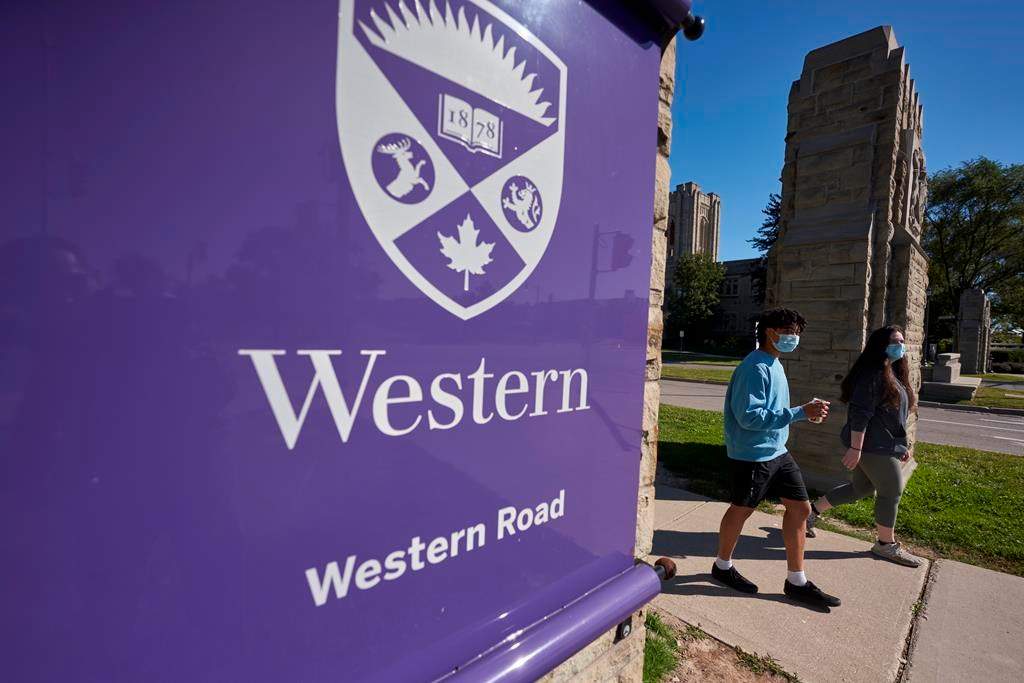 Students walk across campus at Western University in London, Ont., Saturday, Sept. 19, 2020.  Most Canadian universities, including Western are keeping in effect their COVID-19 vaccine and mask requirements for students attending in-person classes after several provinces announced recently plans to end many of the pandemic restrictions. THE CANADIAN PRESS/Geoff Robins.