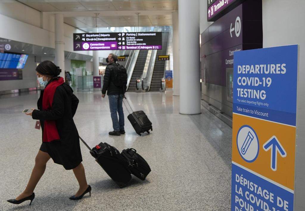 File: People walking to their departure gate at a Canadian airport.