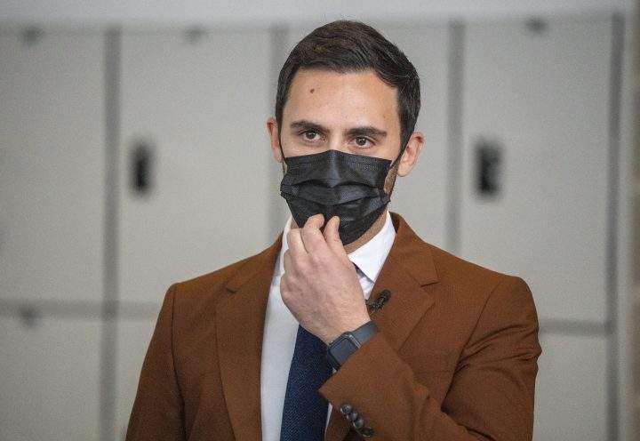 Ontario Education Minister Stephen Lecce adjusts his mask as he tours a COVID-19 vaccination site in Markham, Ontario on Monday January 24, 2022.