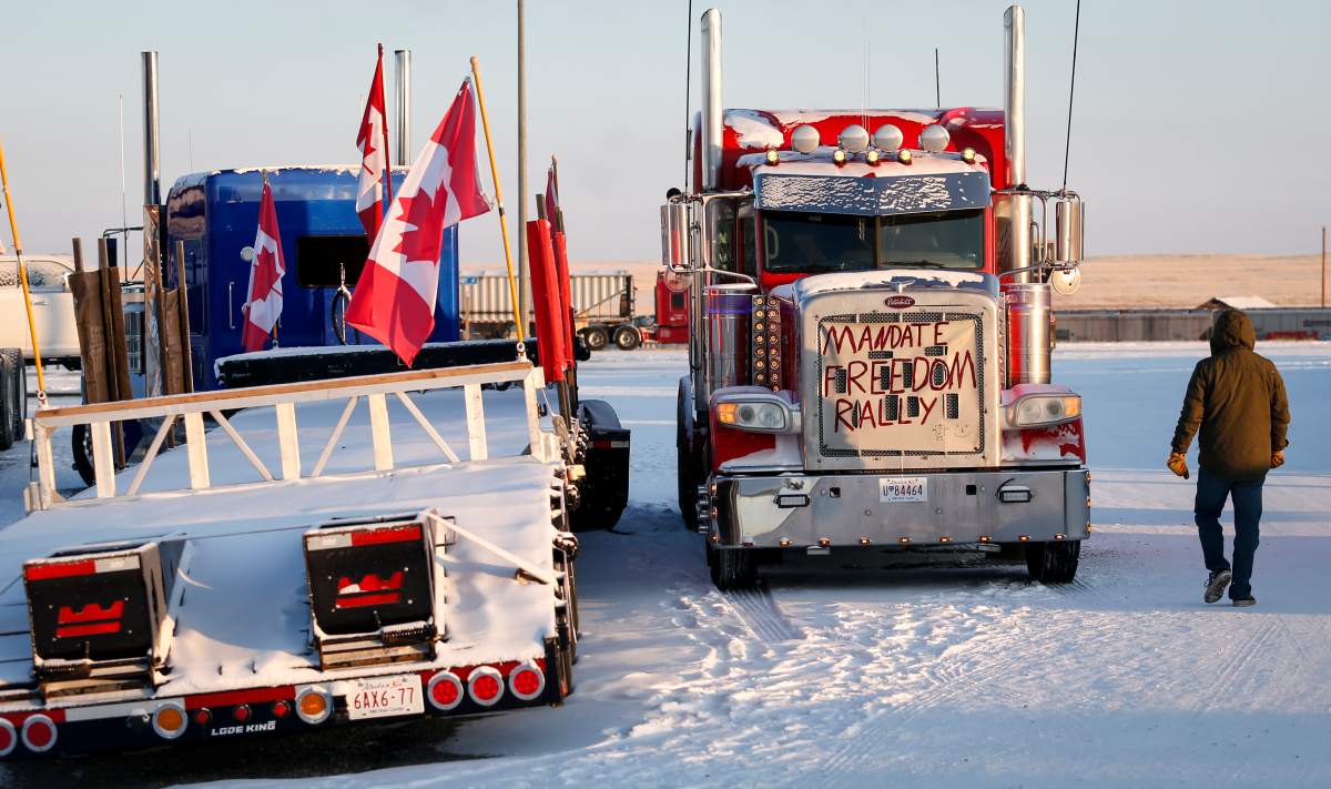 A truck convoy of anti-COVID-19 vaccine mandate demonstrators continue to block the highway at the busy U.S. border crossing in Coutts, Alta., Wednesday, Feb. 2, 2022.