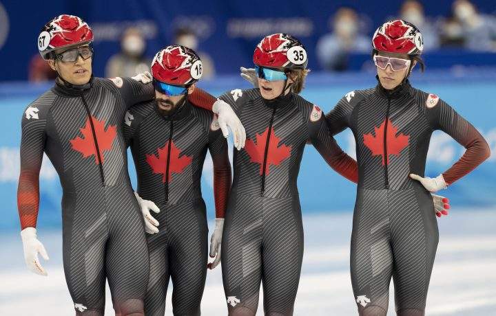 Canada’s Jordan Pierre-Gilles, left, Steven Dubois, second left, Kim Boutin, second right, Florence Brunelle, right, react after finishing fourth in the mixed team relay speed skating final Saturday, Feb. 5, 2022, at the 2022 Winter Olympics in Beijing.