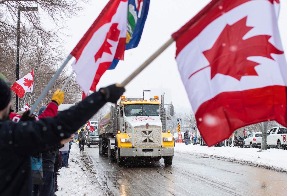 People gather in protest against COVID-19 mandates and in support of a protest against COVID-19 restrictions taking place in Ottawa, in Edmonton, Saturday, Feb. 5, 2022.