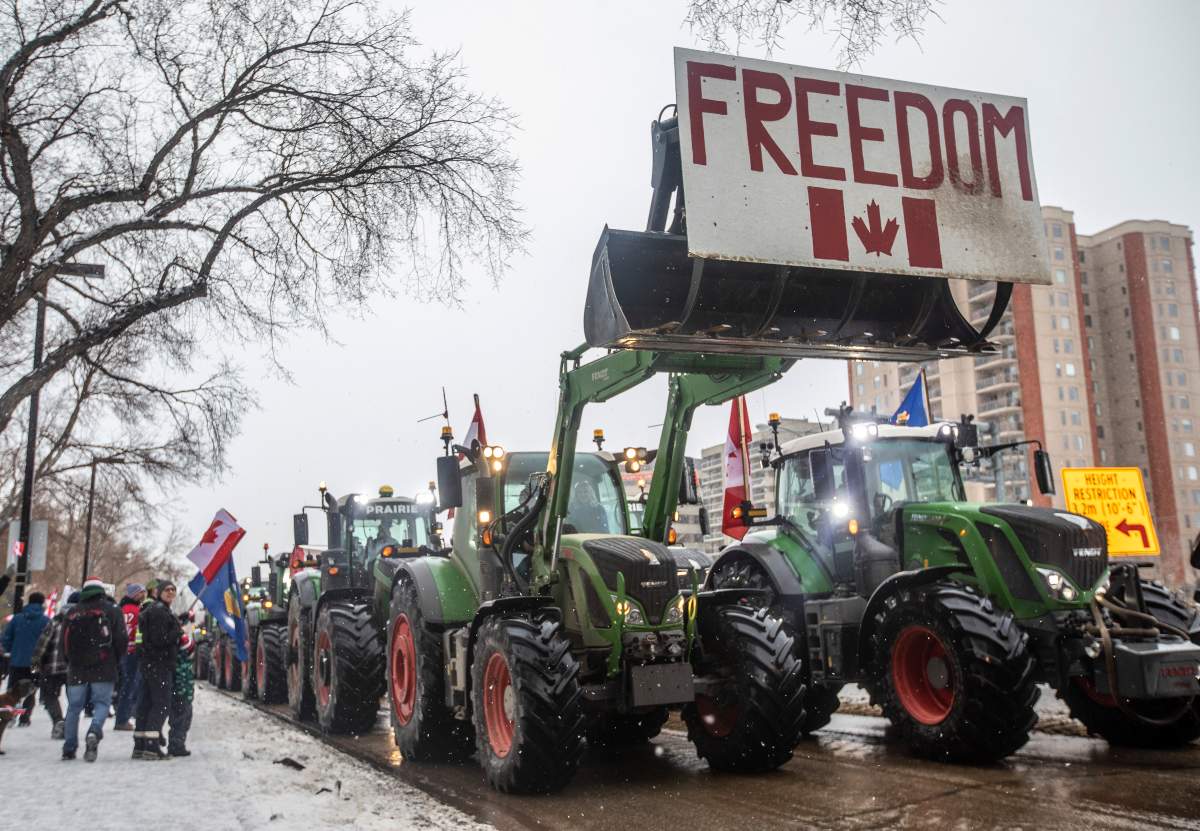 People gather in protest against COVID-19 mandates and in support of a protest against COVID-19 restrictions taking place in Ottawa, in Edmonton, Saturday, Feb. 5, 2022.