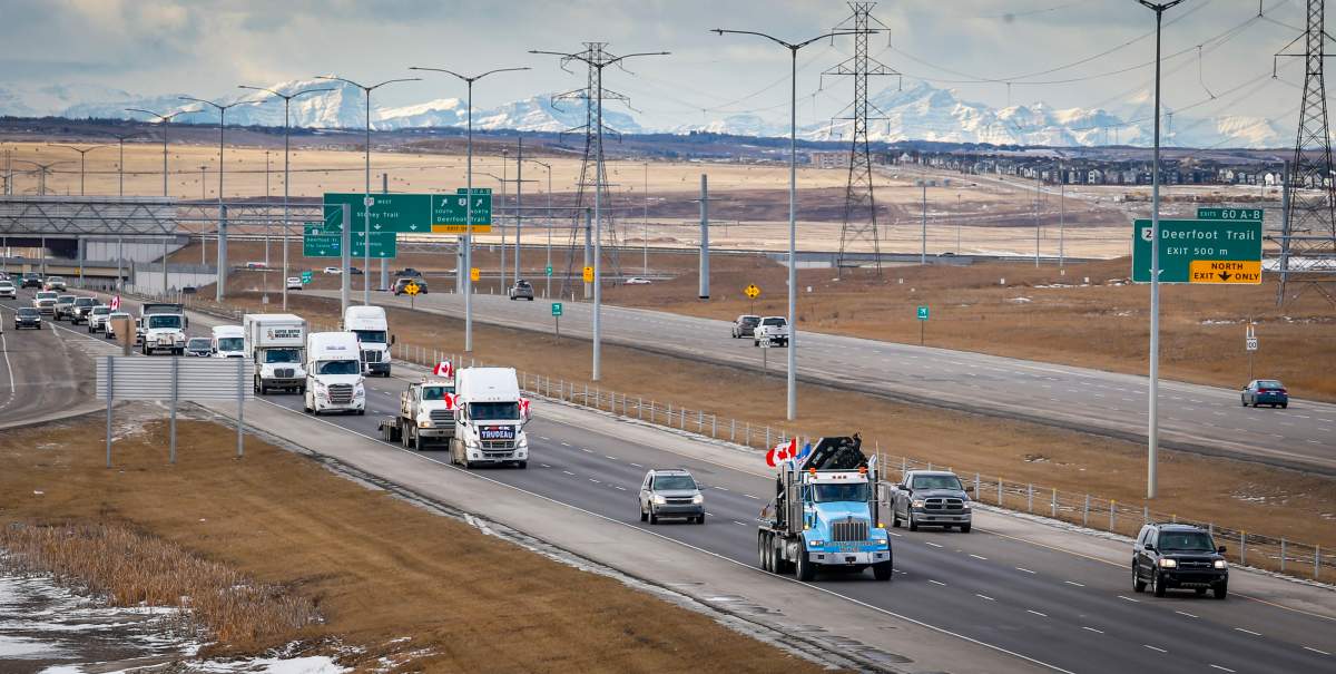 A convoy of anti-COVID-19 vaccine mandate demonstrators drive along a highway in Calgary, Alta., Saturday, Feb. 5, 2022.