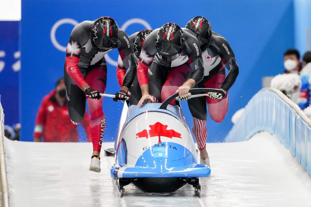 Justin Kripps, Ryan Sommer, Cam Stones and Benjamin Coakwell, of Canada, slide during the 4-man heat 1 at the 2022 Winter Olympics, Saturday, Feb. 19, 2022, in the Yanqing district of Beijing. (AP Photo/Dmitri Lovetsky)