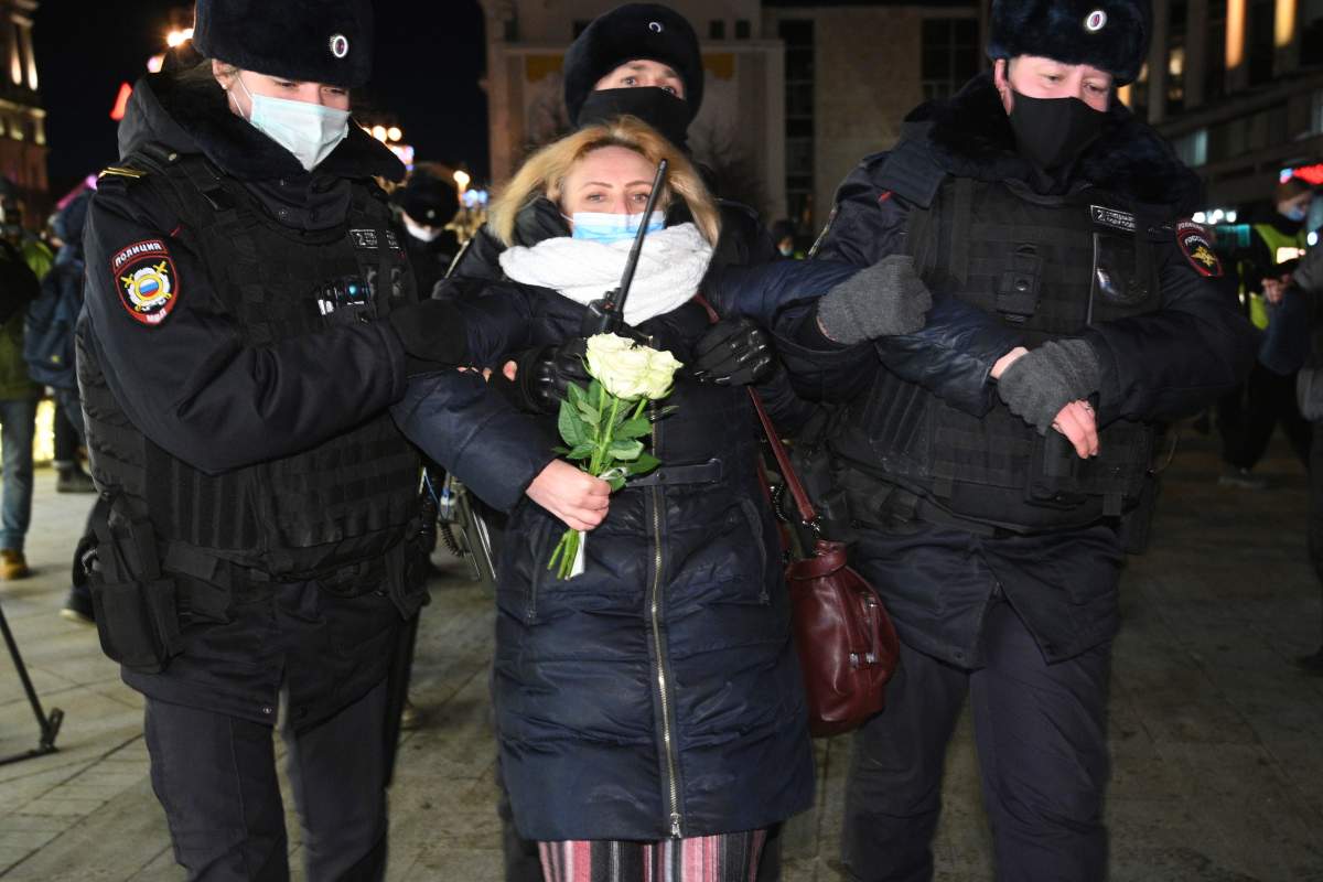 Police officer detain a woman during an action against Russia's attack on Ukraine in Moscow, Russia, Thursday, Feb. 24, 2022. Hundreds of people gathered in the center of Moscow on Thursday, protesting against Russia's attack on Ukraine. Many of the demonstrators were detained. Similar protests took place in other Russian cities, and activists were also arrested.