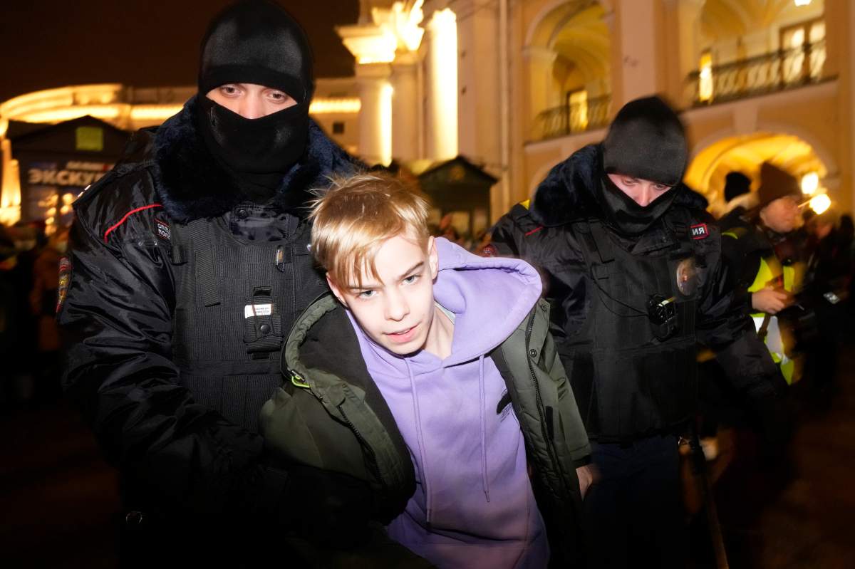 Police officers detain a young demonstrator in St. Petersburg, Russia, Thursday, Feb. 24, 2022. Hundreds of people gathered in Moscow and St.Petersburg on Thursday, protesting against Russia’s attack on Ukraine. Many of the demonstrators were detained. Similar protests took place in other Russian cities, and activists were also arrested.