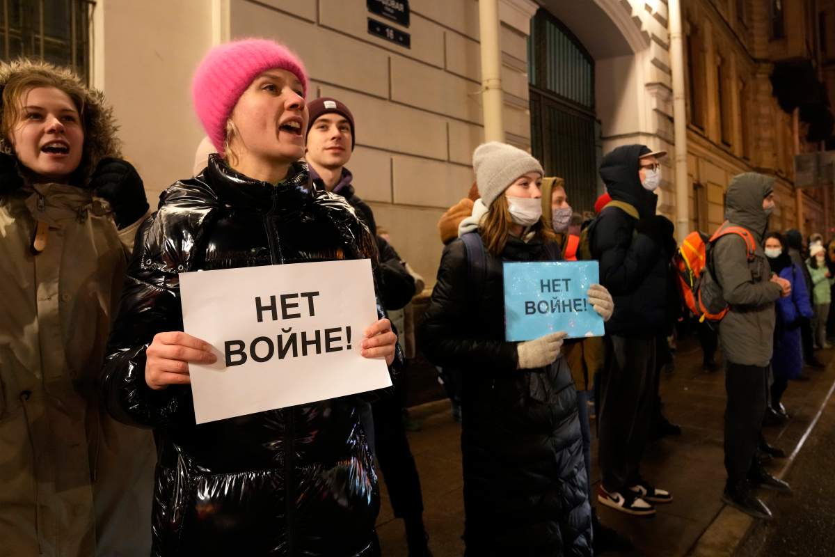 Demonstrators hold signs ‘No war!’, in St. Petersburg, Russia, Thursday, Feb. 24, 2022. Hundreds of people gathered in the center of Moscow on Thursday, protesting against Russia’s attack on Ukraine. Many of the demonstrators were detained. Similar protests took place in other Russian cities, and activists were also arrested.