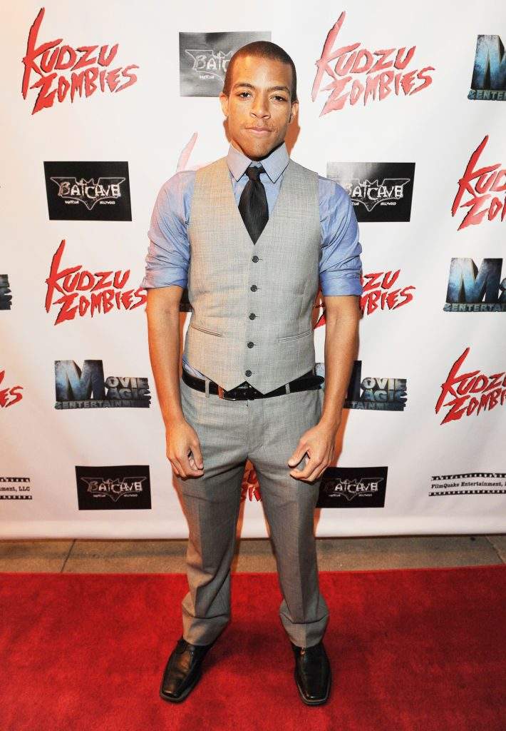 Moses J. Moseley poses on a red carpet ahead of a movie premiere.