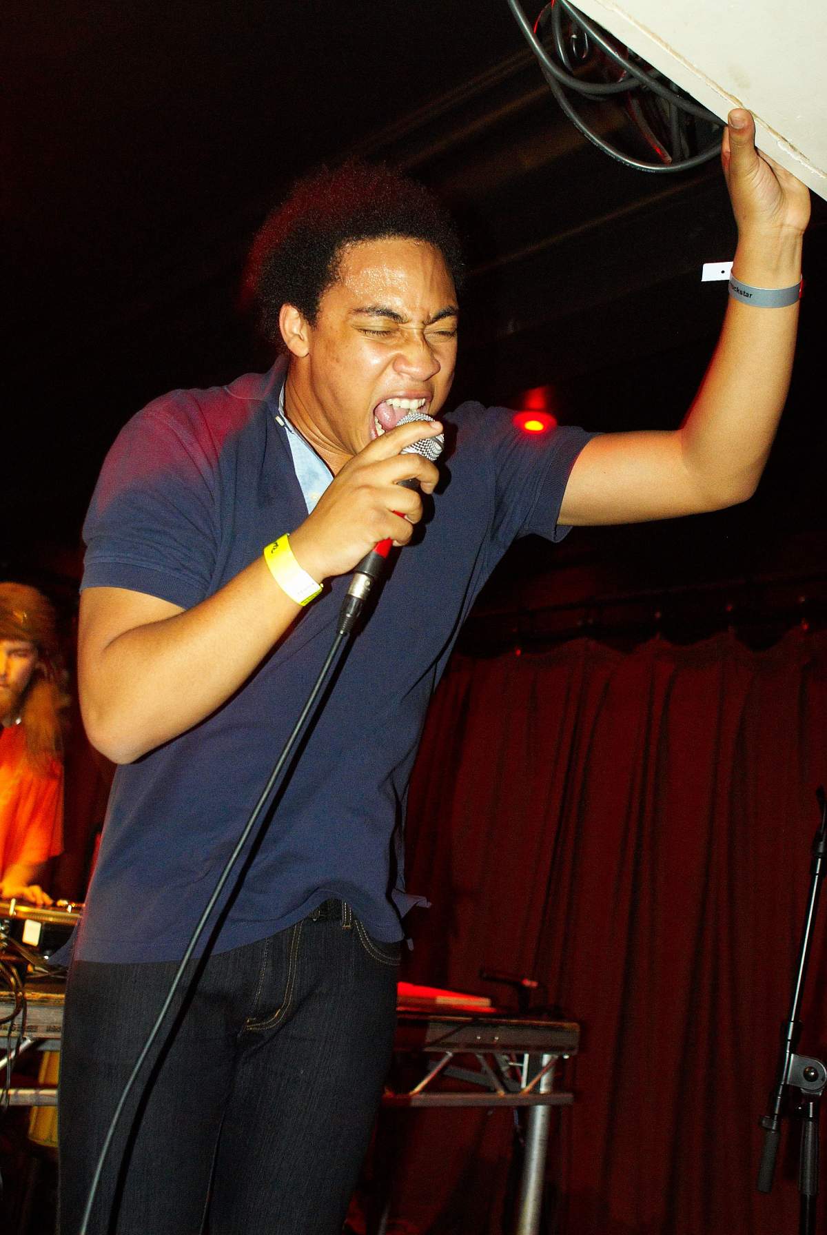 Cadence Weapon (Rollie Pemberton) performing on stage in the U.K. in 2008.