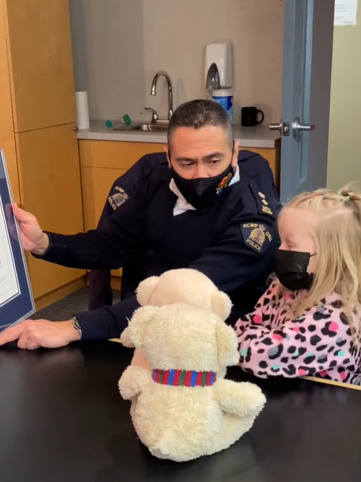 Six-year-old Jane Deelstra of Kamloops, B.C. receives a certificate for bravery from the Kamloops RCMP on Tues. Feb. 22, 2022.