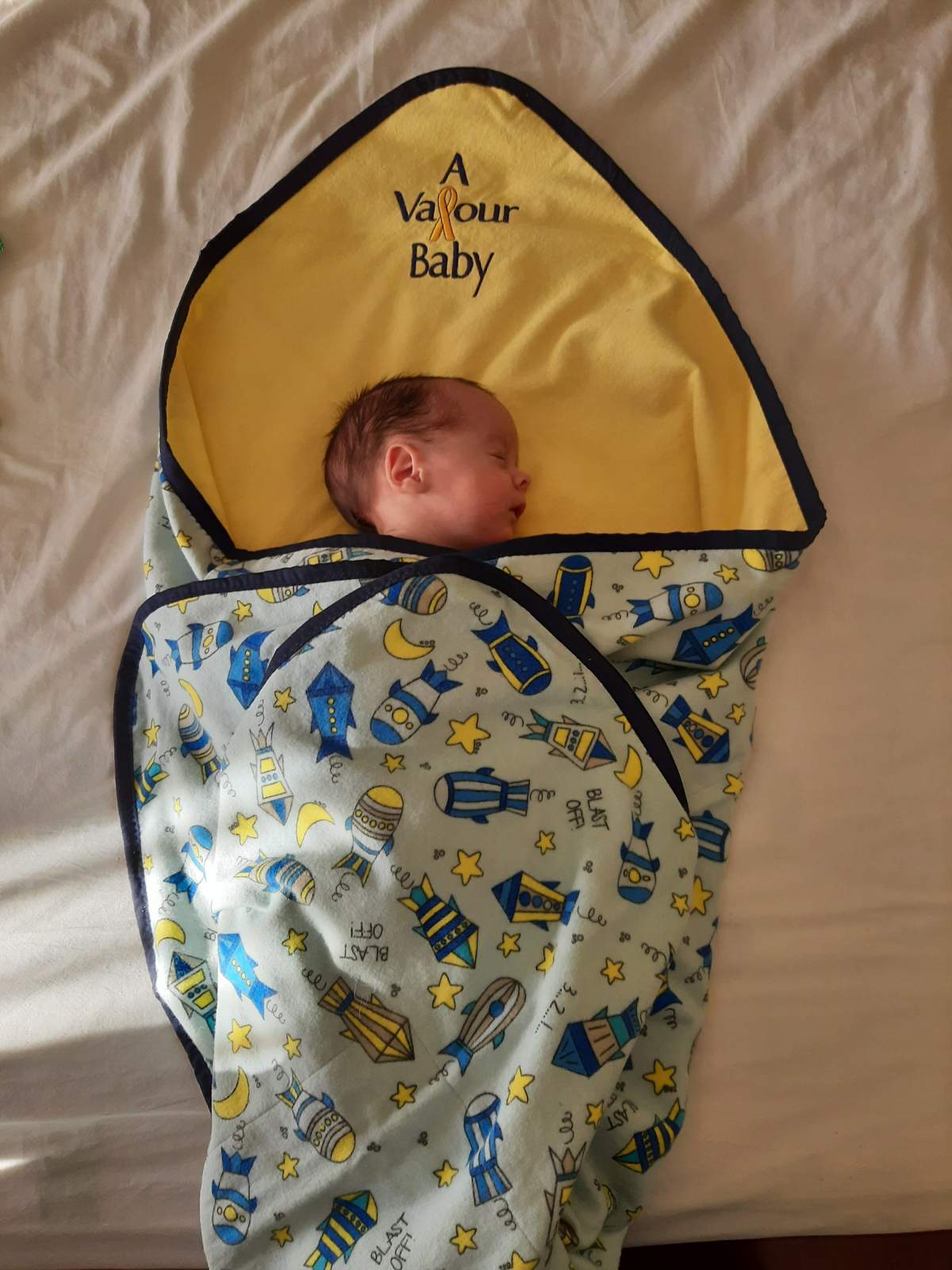 A baby wrapped in a Valour Baby blanket at Valour Place in Edmonton, Alta.
