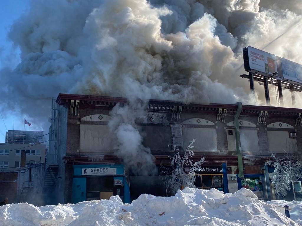 Smoke pours out of a building on Langside Street