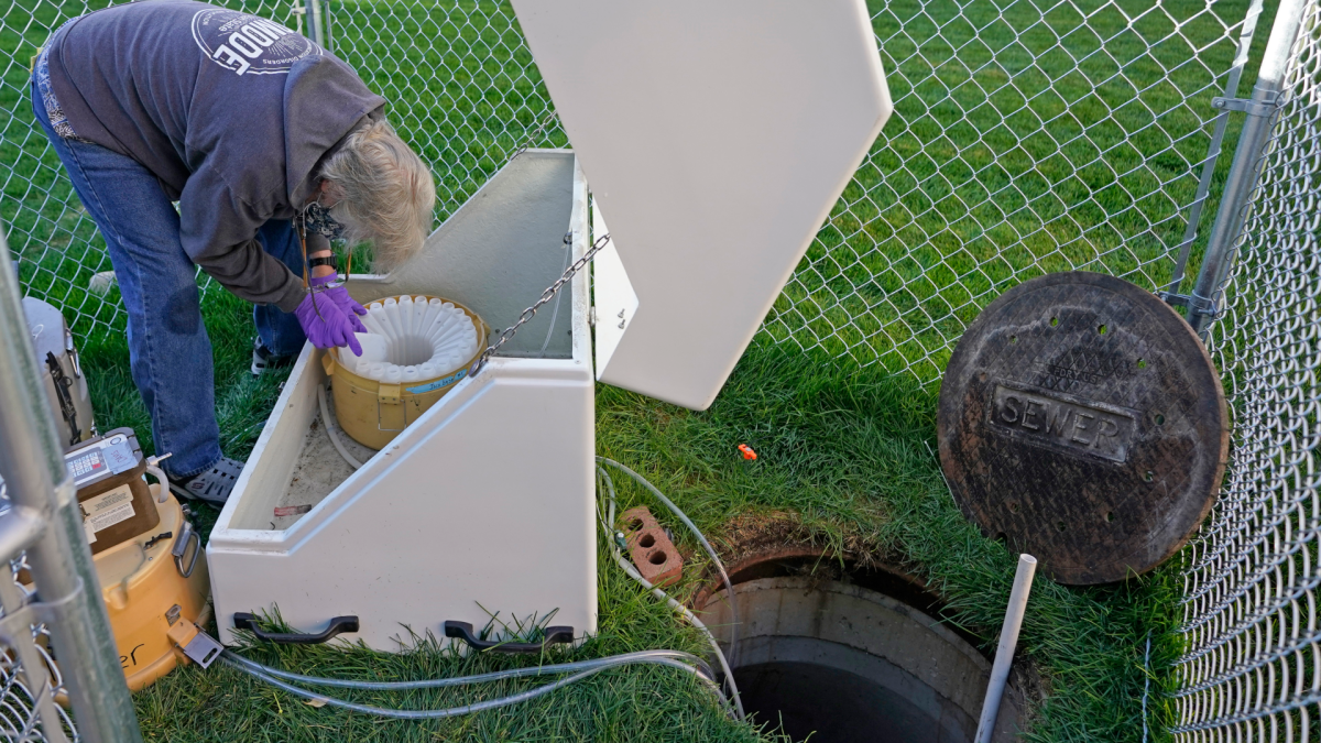 A civil & environmental engineering professor collects sewage samples from the dorms at Utah State University Wednesday, Sept. 2, 2020, in Logan, Utah.