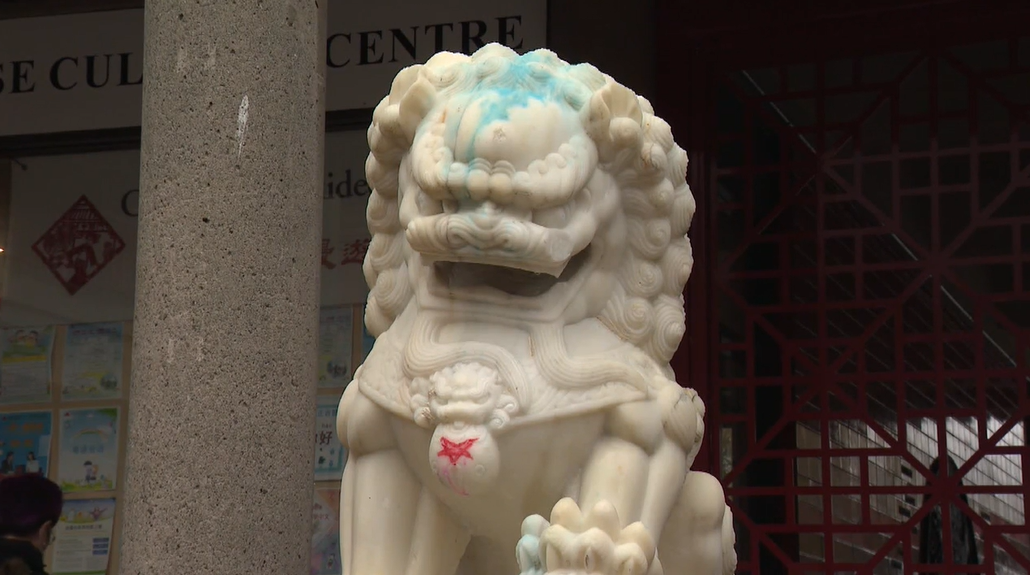 A defaced lion statue outside the Vancouver Chinese Cultural Centre.