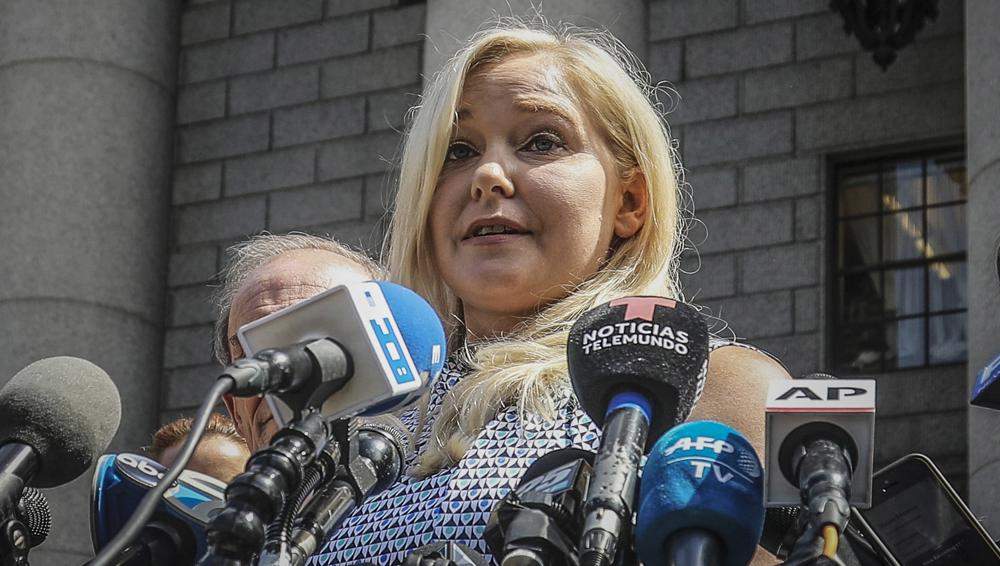 FILE - Virginia Roberts Giuffre holds a news conference outside a Manhattan court following the jailhouse death of Jeffrey Epstein, Aug. 27, 2019, in New York. A tentative settlement has been reached in a lawsuit accusing Prince Andrew of sexually abusing a 17-year-old American, according to a court filing Tuesday, Feb. 15, 2022.