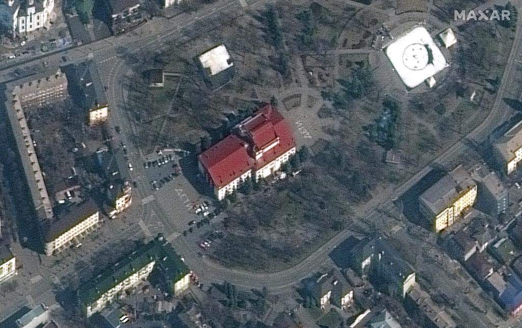 This satellite image provided by Maxar Technologies shows the Mariupol Drama Theater in Mariupol, Ukraine on Monday, March 14, 2022. The Maxar satellite imagery firm said images from Monday showed the word “children” had been written in large white letters in Russian in front of and behind the building. (Maxar Technologies via AP)