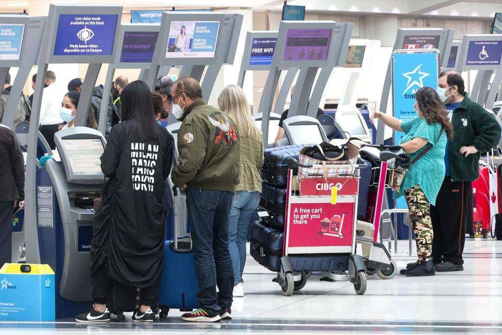 Passengers check in at Toronto's Pearson Airport on Friday, Oct. 29, 2021. Federal Conservatives on March 24 are tabling a motion asking for all federal COVID-19 vaccine mandates be lifted.