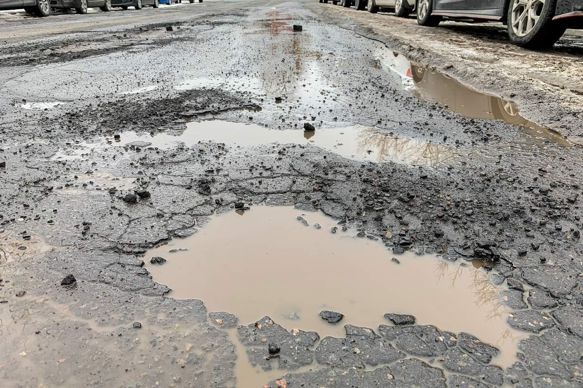 Potholes are shown on a street in February 24, 2021.