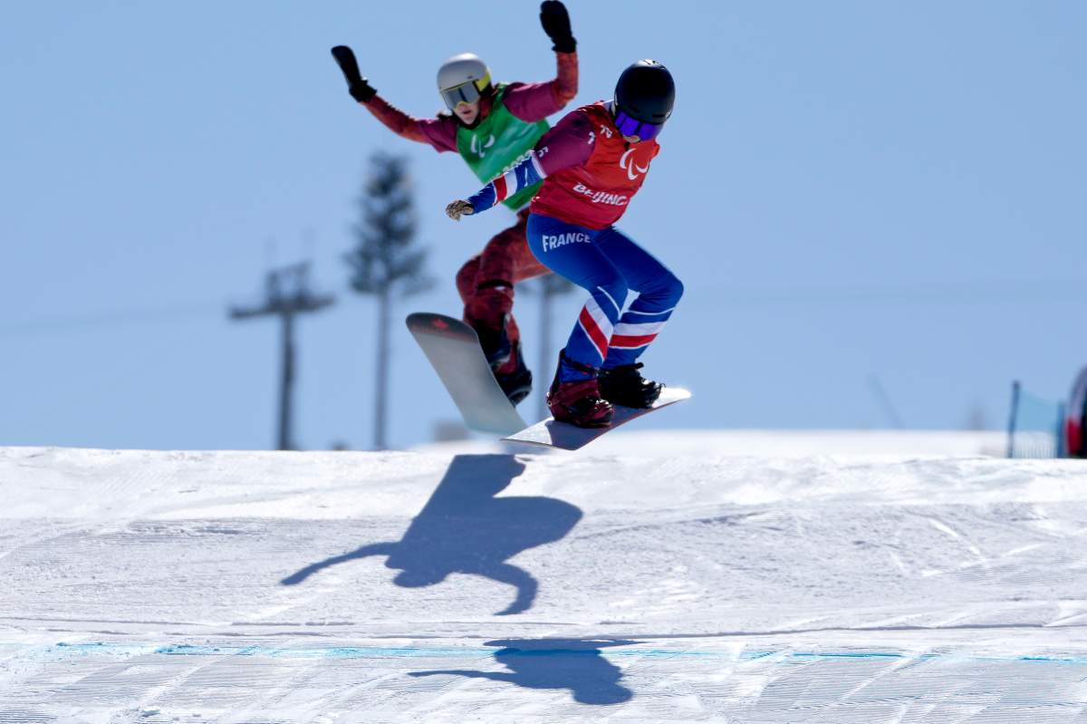 Cecile Hernandez, right, of France, and Canada's Lisa Dejong compete during the women's snowboard cross SB-LL2 semifinal at the 2022 Winter Paralympics, Monday, March 7, 2022, in Zhangjiakou, China.