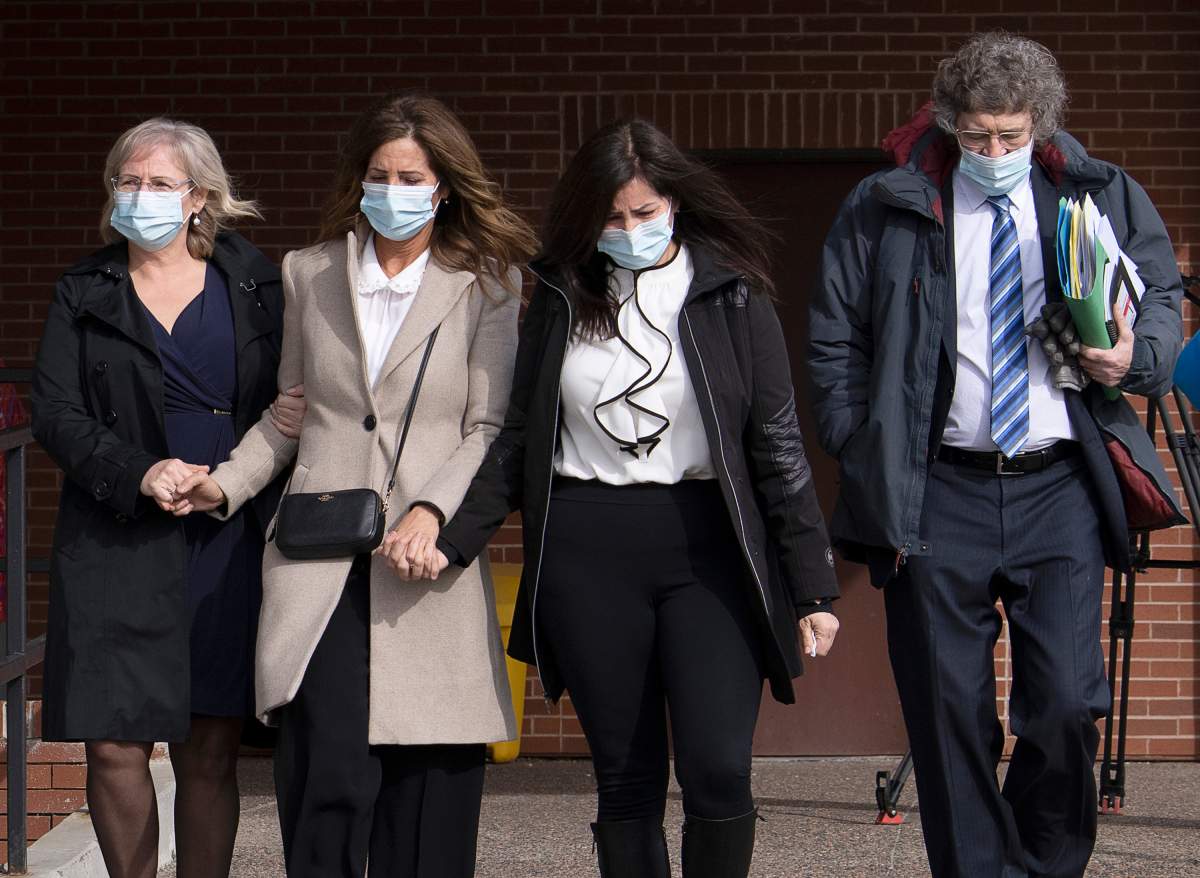 Lisa Banfield, second from left, spouse of Gabriel Wortman, is escorted by friends along with lawyer James Lockyer, right, as they leave Nova Scotia Provincial court in Dartmouth on Wednesday, March 9, 2022.