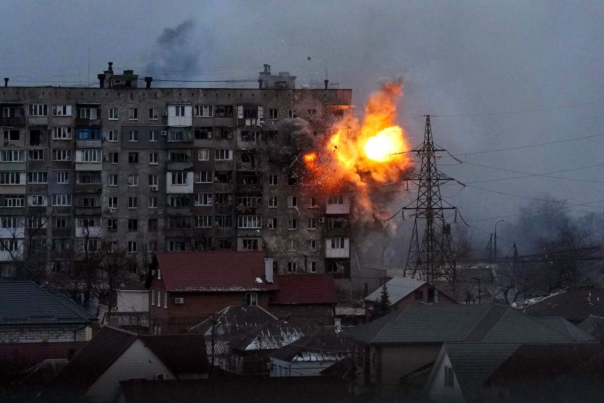 An explosion is seen in an apartment building after Russian’s army tank fires in Mariupol, Ukraine, Friday, March 11, 2022.