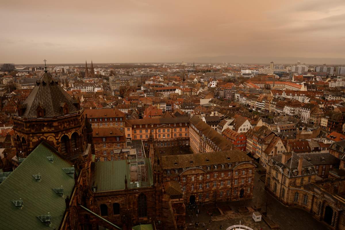 Taken from the top of the Strasbourg cathedral, the eastern France city of Strasbourg seems to be covered by an orange light as Sahara dust is moving in over the city