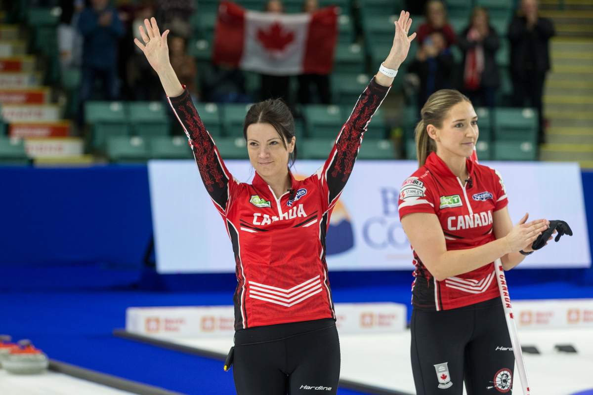 Canada skip Kerri Einarson, left, and lead Briane Meilleur acknowledge the crowd after defeating Sweden 8-7 in the bronze medal game at CN Centre during the Women's World Curling in Prince George, B.C., on Sunday, March 27, 2022.
