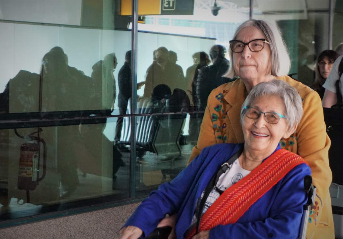 Métis Elder Angie Crerar and Métis Nation of Alberta President Audrey Poitras makes their way to the bus that will take them to their hotel in Rome on March 27, 2022.