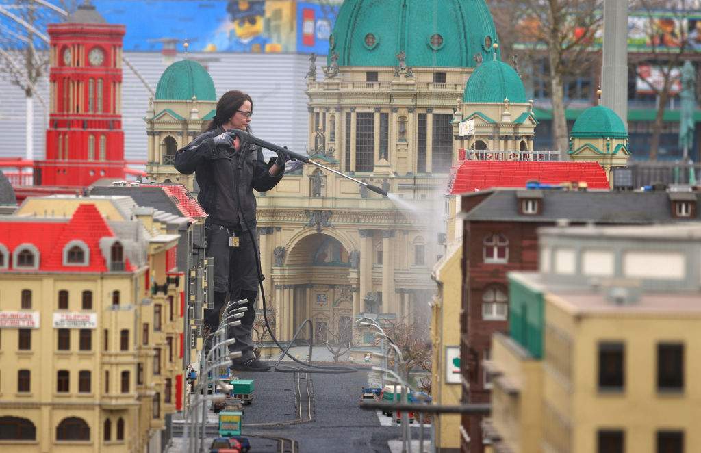 A workers cleans Legoland after a Saharan dust cloud blanketed it in particles