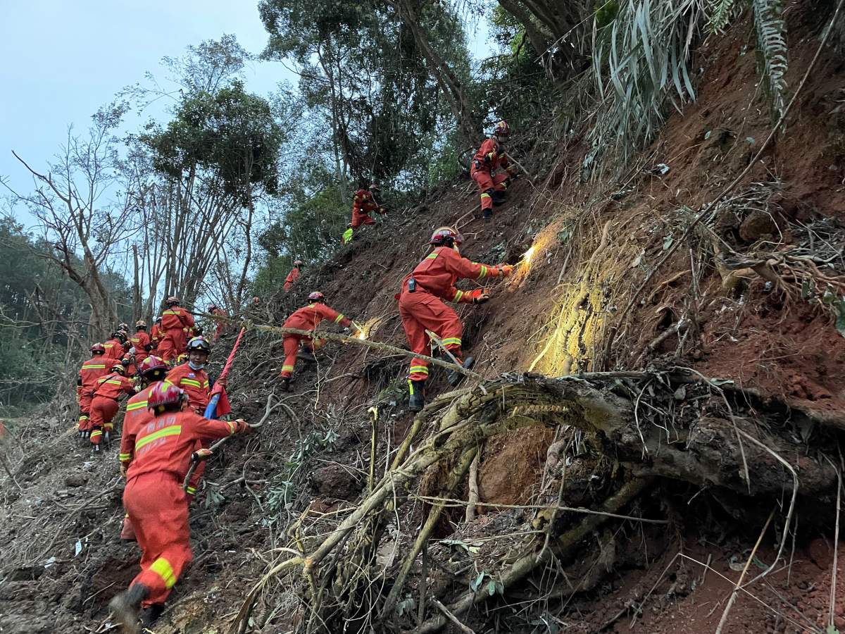 Photo taken with a mobile phone shows rescuers searching for the black boxes at a plane crash site in Tengxian County, south China’s Guangxi Zhuang Autonomous Region, March 22, 2022.