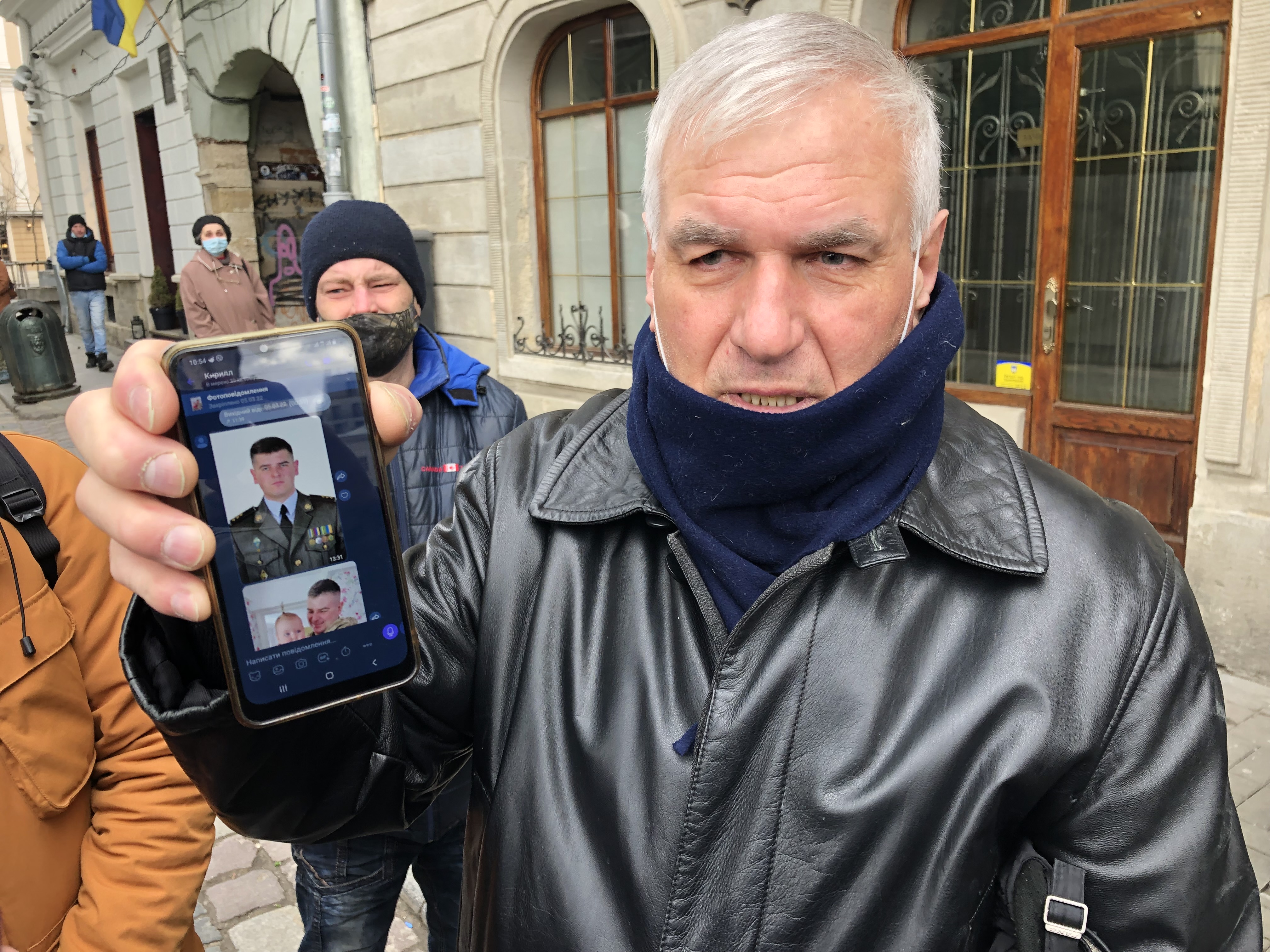 The father of Vasyl Vushuvanyi shows a photo of his son, a member of the Armed Forces of Ukraine killed March 4. 