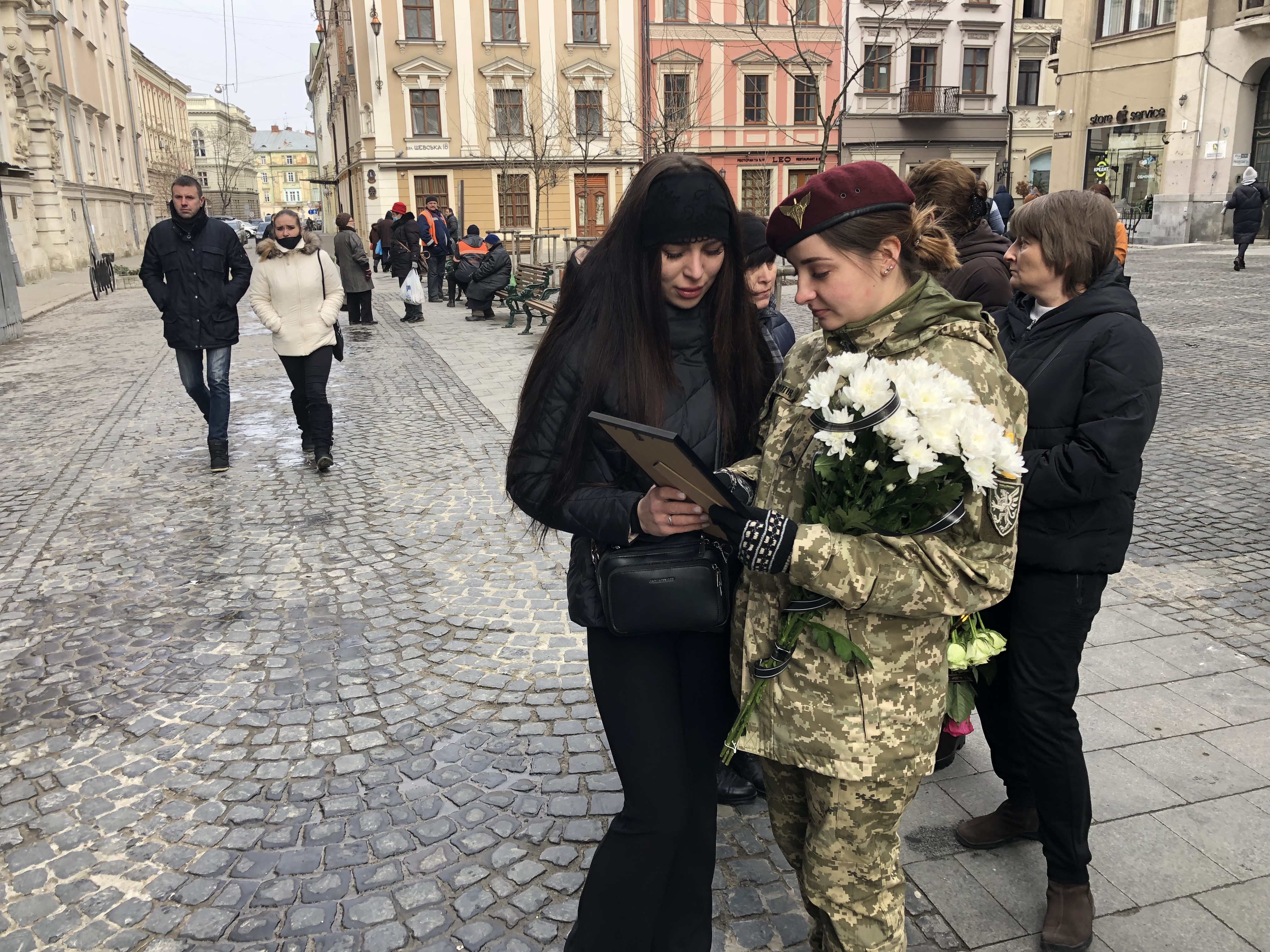 Girlfriend of a soldier killed on March 4, outside Saints Peter and Paul Garrison Church, Lviv, Ukraine, March 9, 2022.