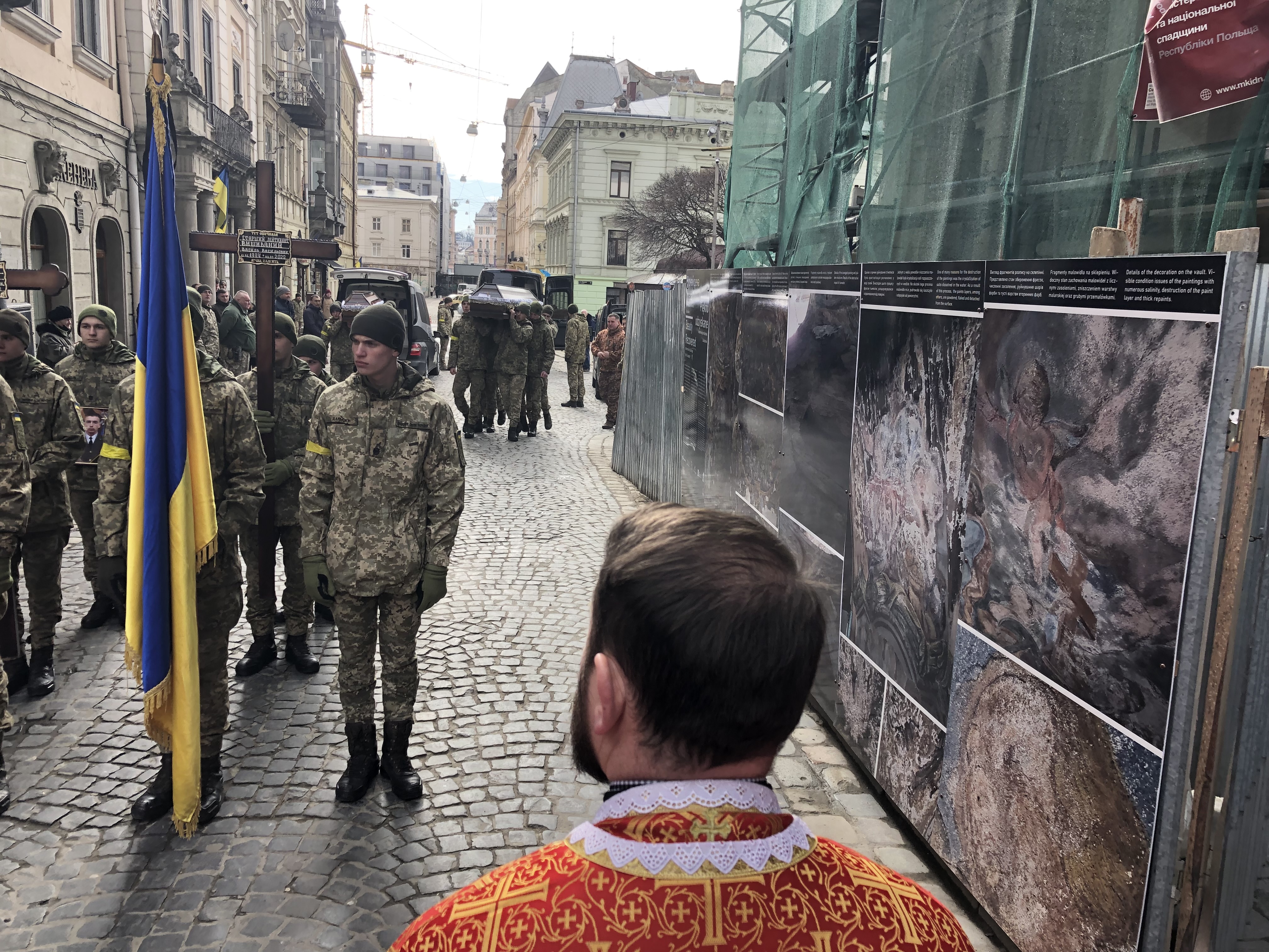 Priest awaits the arrival of the caskets of three fallen soldiers, Lviv, Ukraine, March 9, 2022.