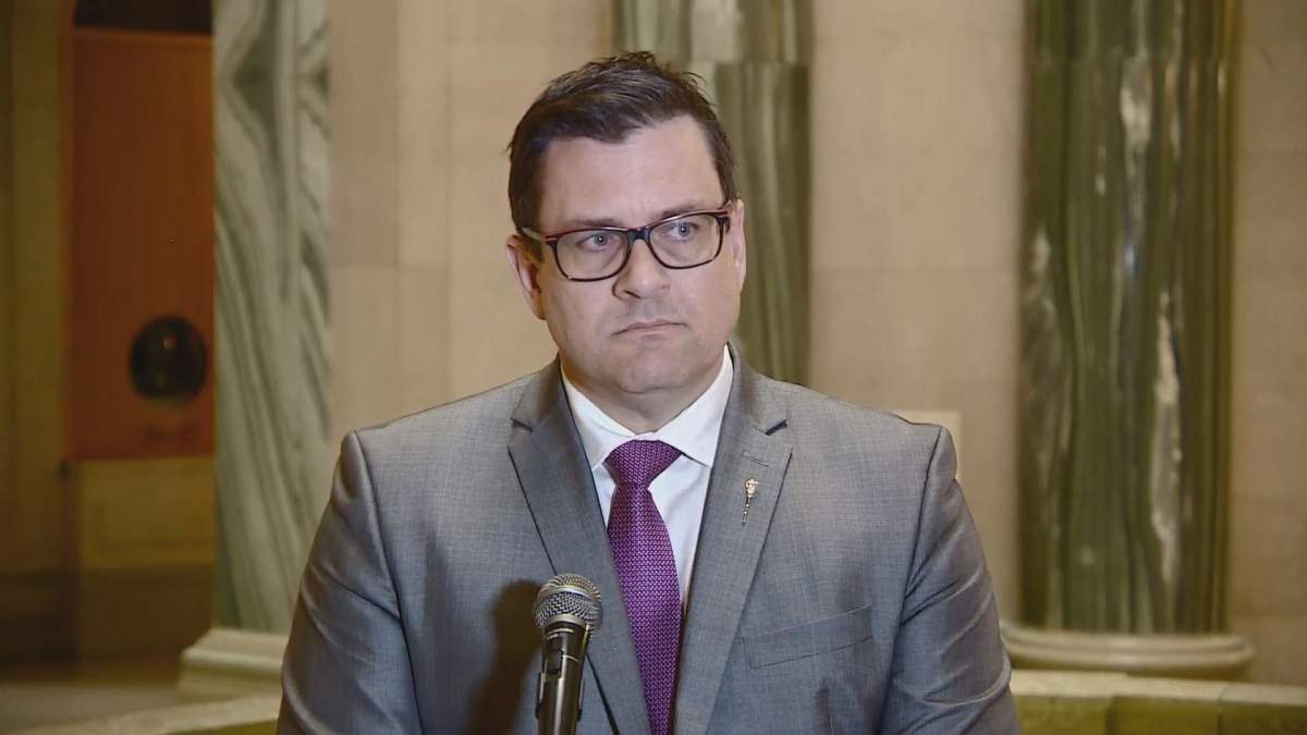Saskatchewan Health Minister Paul Merriman speaks to reporters in Regina.
