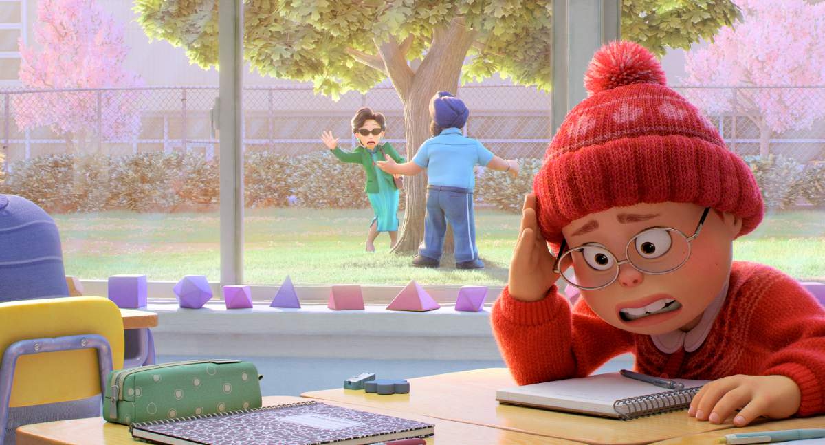 A still from Pixar's 2022 film Turning Red. The main character looks embarrassed at school as we can see her mother in the background.