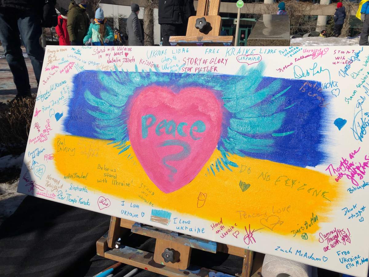 A painting by Moncton artist André Boulard is seen at a rally for solidarity with Ukraine on Mar. 5, 2022.